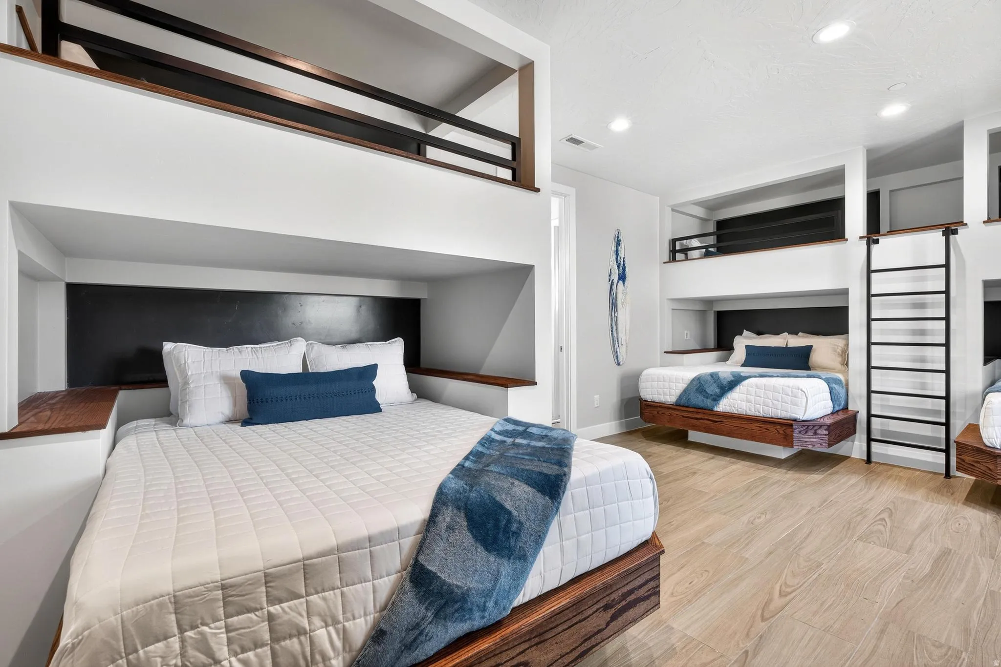 Built-in bunk beds with integrated wood-finish shelving and black accent panels