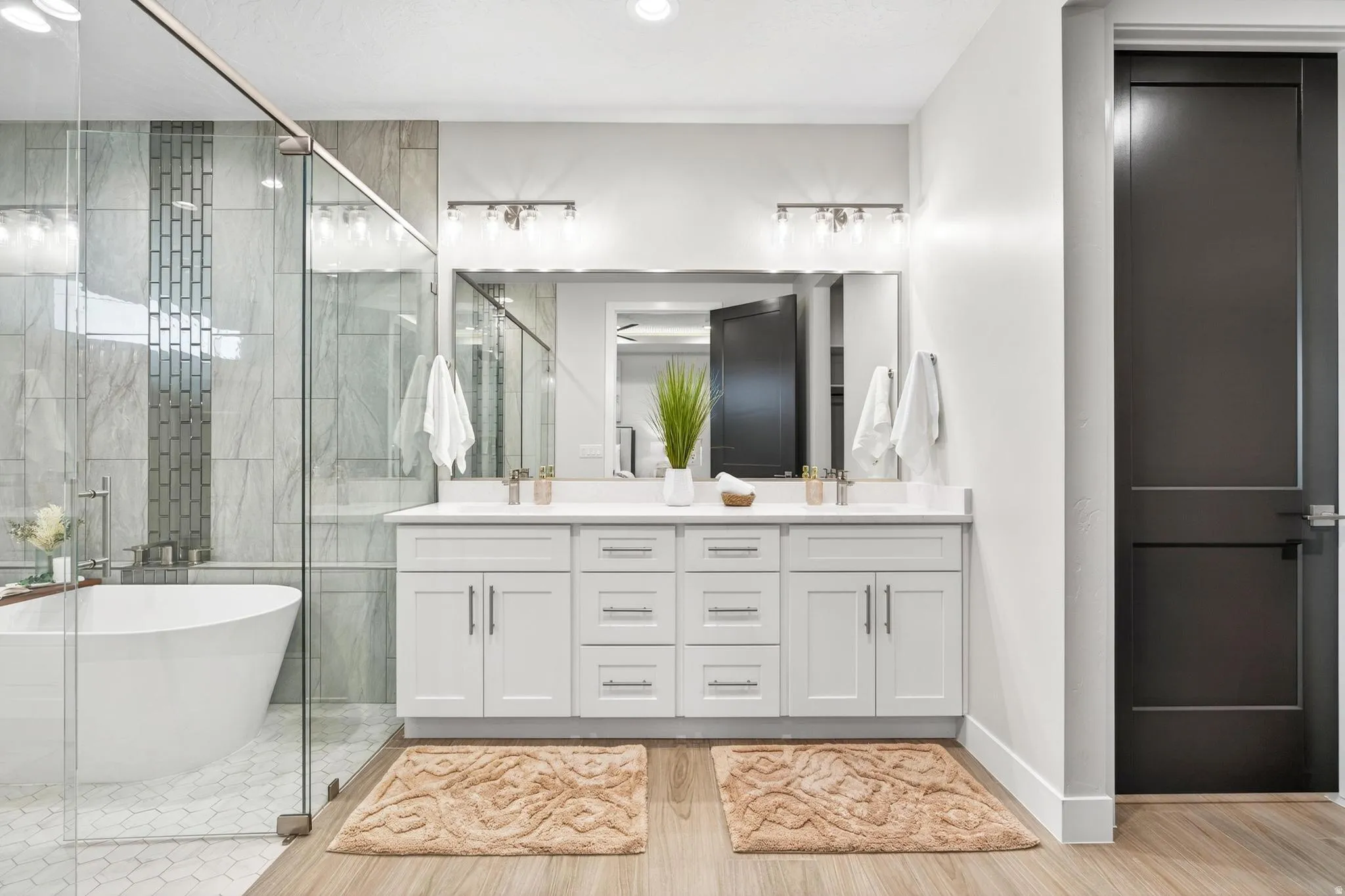 Dual vanity with white cabinetry, quartz countertop, and brushed nickel fixtures
