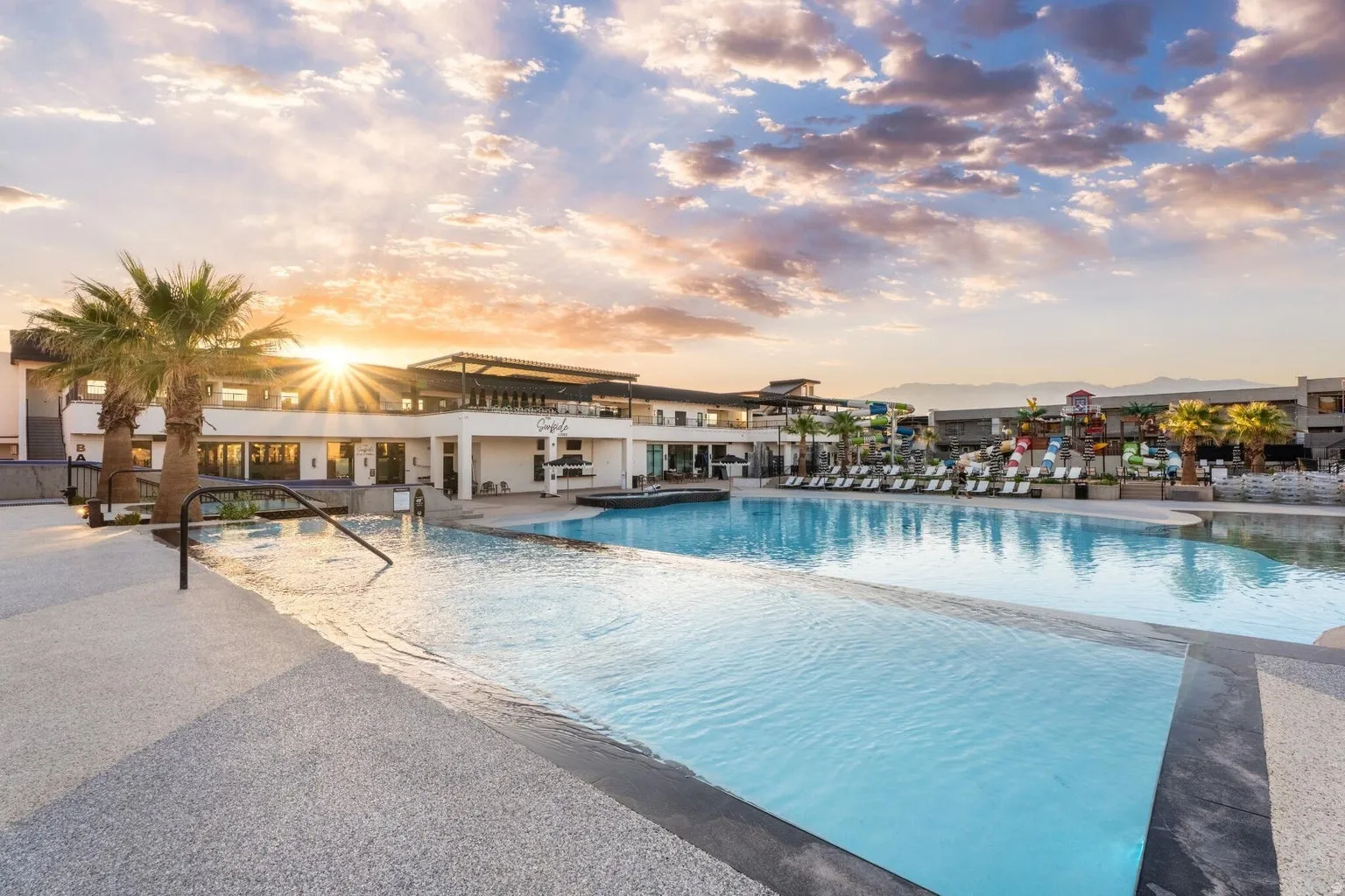Expansive outdoor pool with an infinity edge, surrounded by a large concrete deck