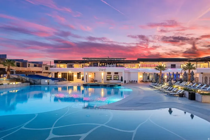Expansive multi-level pool with patterned basin, surrounding lounge deck, and integrated spa