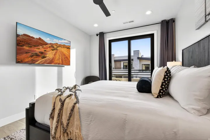 Hardwood-style flooring, recessed lighting, ceiling fan, and a built-in wall-mounted television