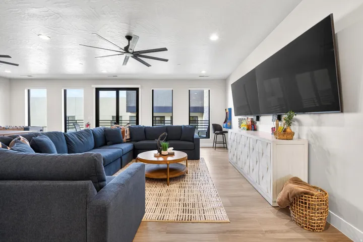 Spacious room featuring wood-finish flooring and multiple windows