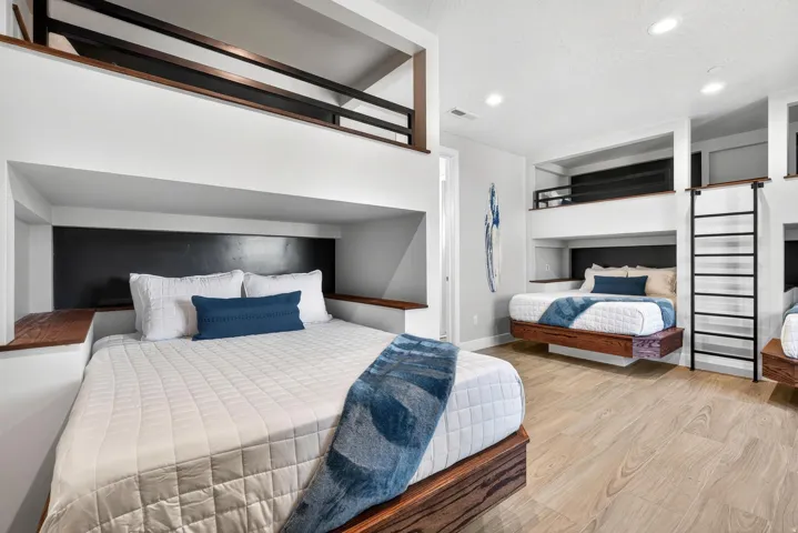 Built-in bunk beds with integrated wood-finish shelving and black accent panels