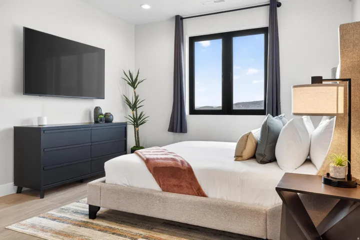 Recessed lighting illuminates wood-finish flooring