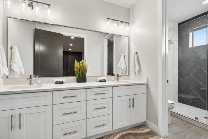 Dual vanity with light-toned countertops and undermount sinks