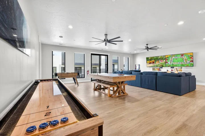 Spacious room with wood-finish flooring, recessed lighting, and multiple windows