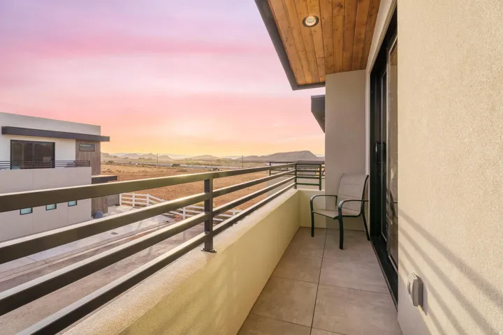 Balcony with a wood-finish ceiling, recessed lighting, and a sliding glass door