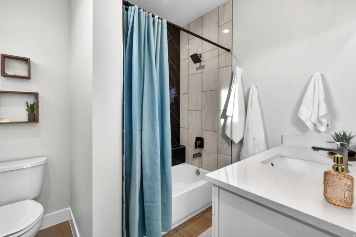 White vanity with a solid surface countertop and undermount sink