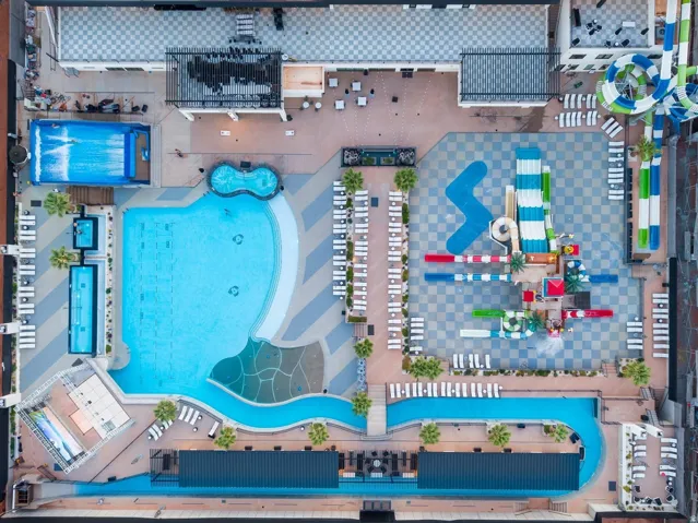Expansive aquatic complex featuring multiple swimming pools, a lazy river, and a water slide park