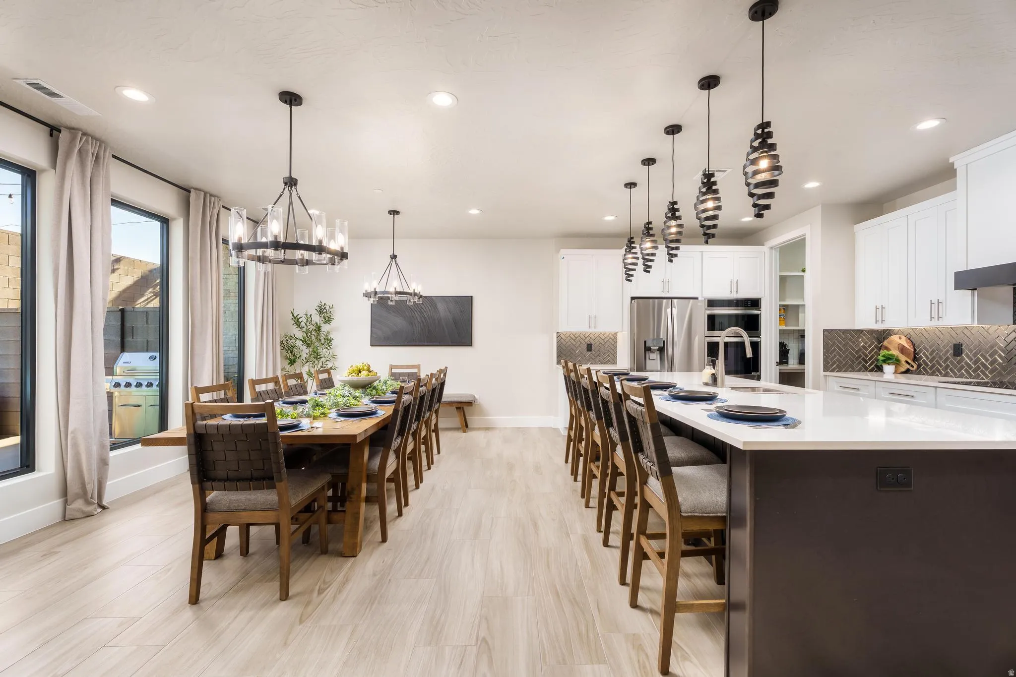 Wood-finish flooring, recessed lighting, and large windows with dark frames