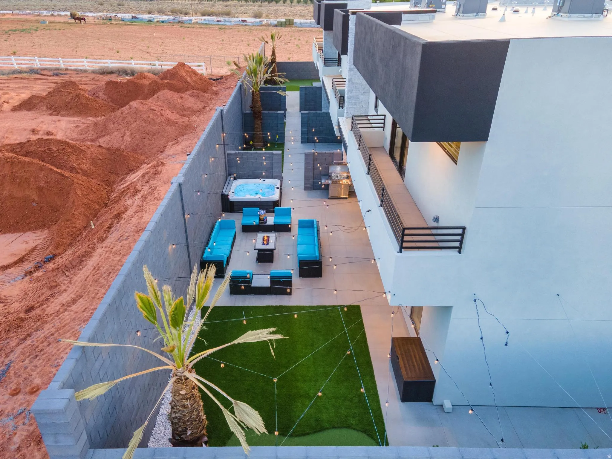 Private outdoor living area featuring a hot tub, paved patio, and a putting green