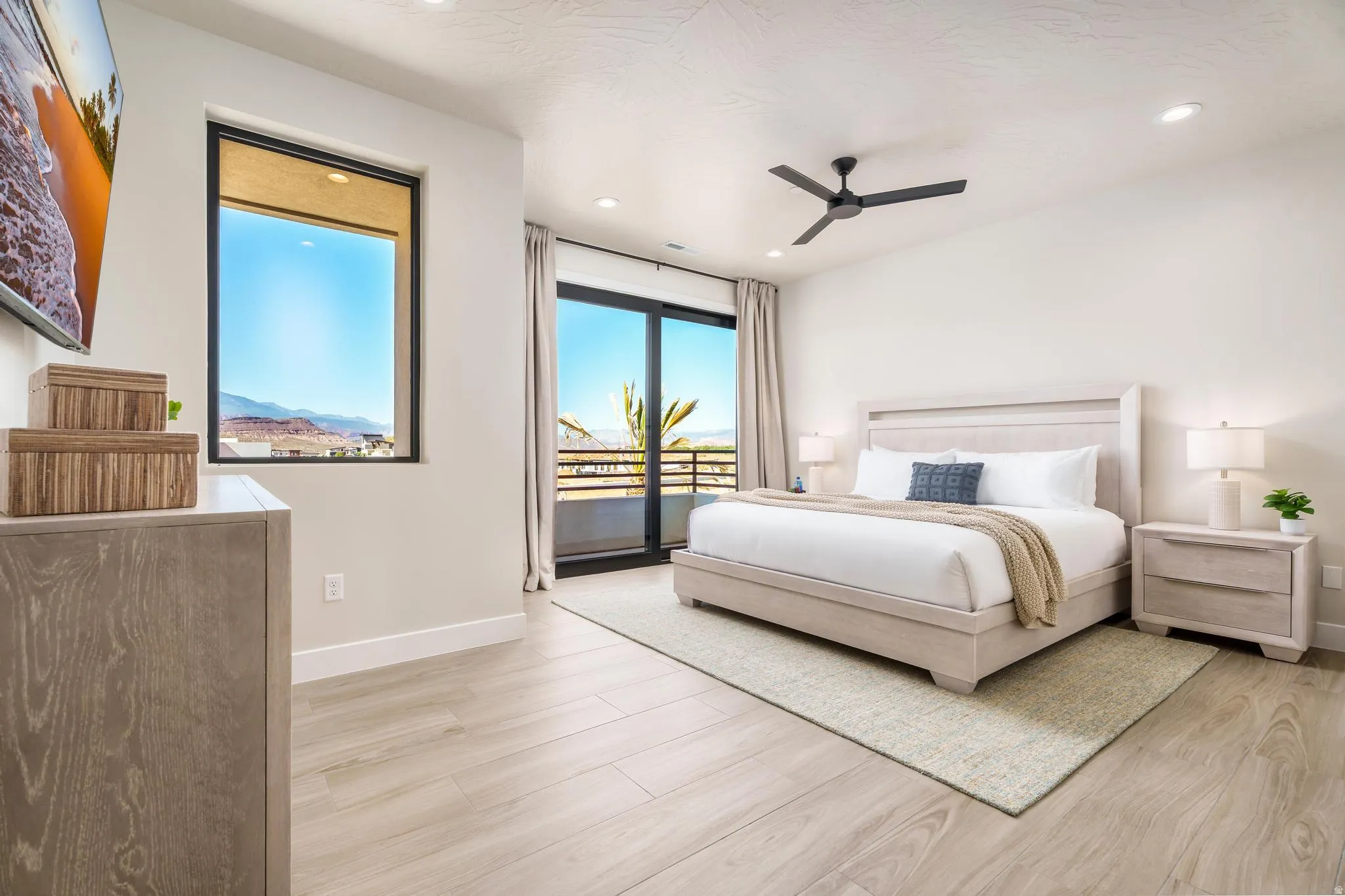 Expansive room featuring wood-finish flooring, a ceiling fan, recessed lighting, and a sliding glass door opening to a balcony
