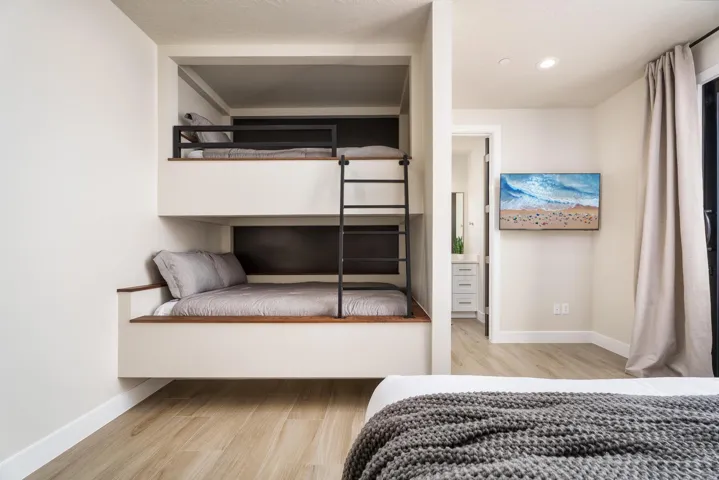 Built-in bunk beds with integrated ladder and wood-finish accents