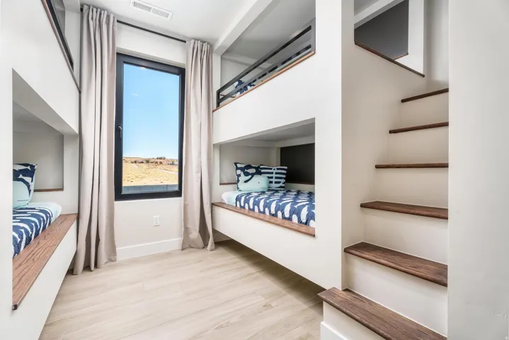 Built-in bunk beds with integrated wood-finish steps
