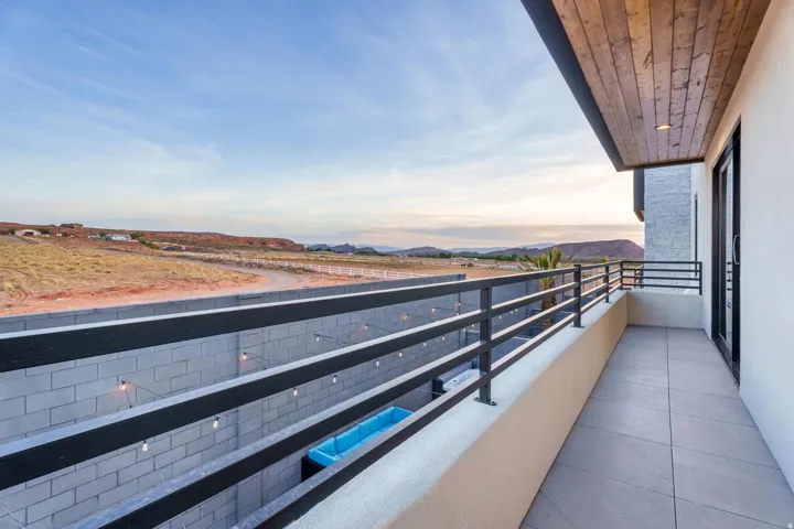 Balcony featuring tiled flooring, a metal railing, and a wood-paneled ceiling with recessed lighting