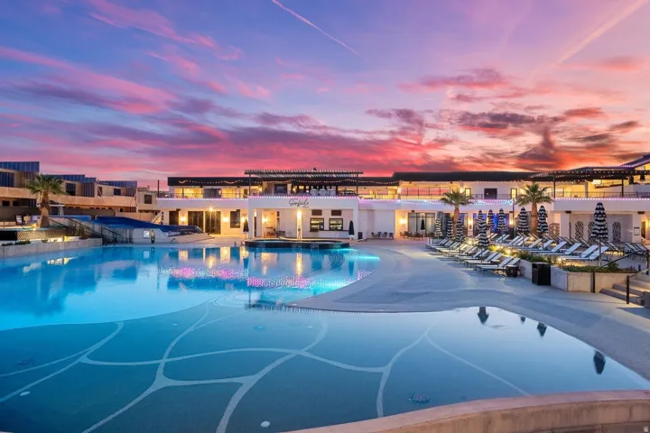 Expansive multi-level swimming pool with integrated lighting and decorative mosaic work