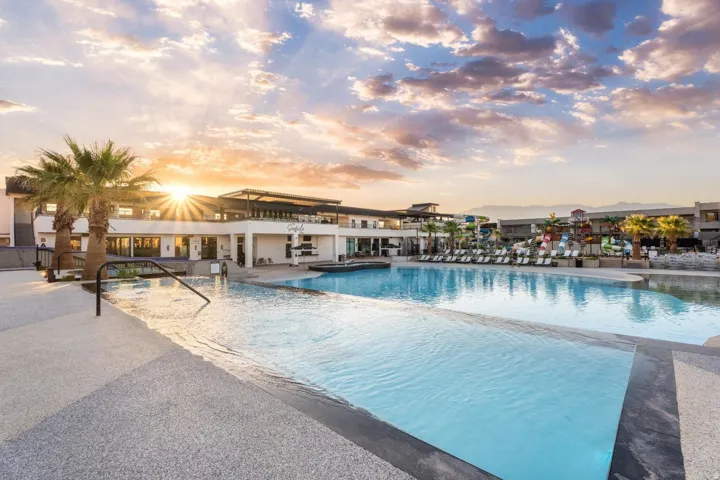 Expansive outdoor pool with an infinity edge, surrounded by a large concrete deck