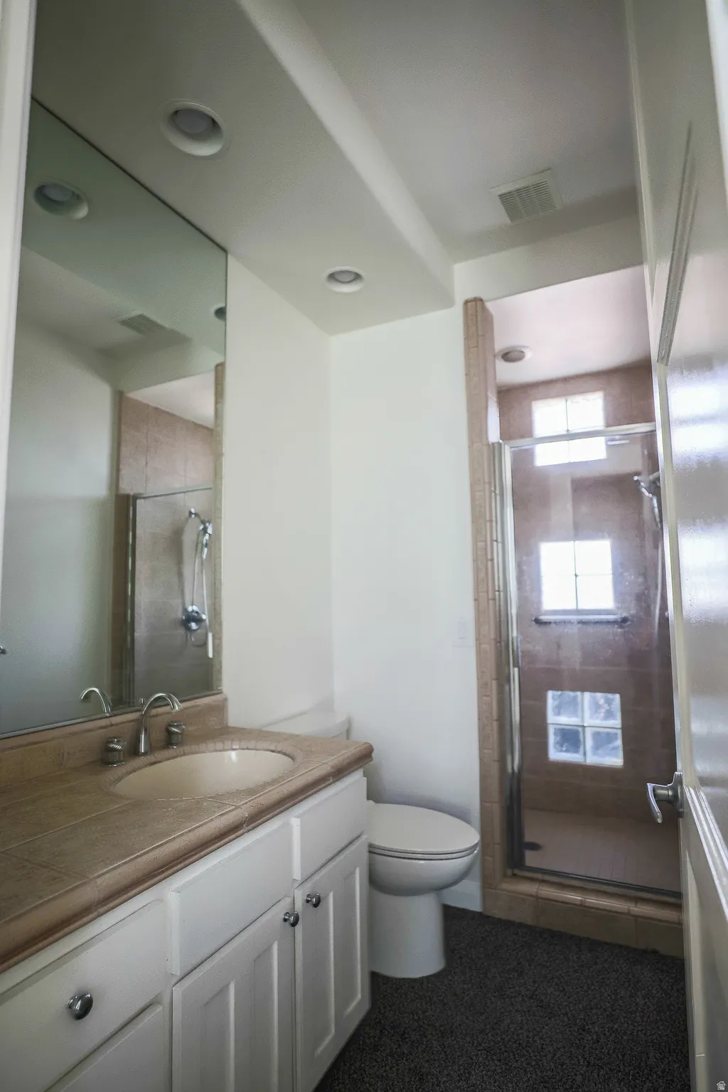 White vanity with dual cabinet storage and chrome hardware