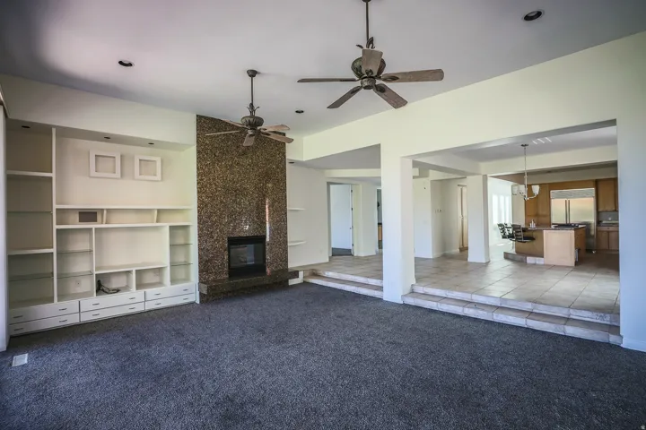 Great room with built in cabinetry, fireplace, (Pre-leasing photo)