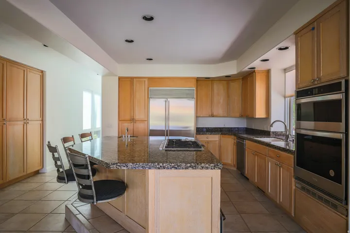 Kitchen with breakfast bar and built in oven and microwave (Pre-leasing photo)