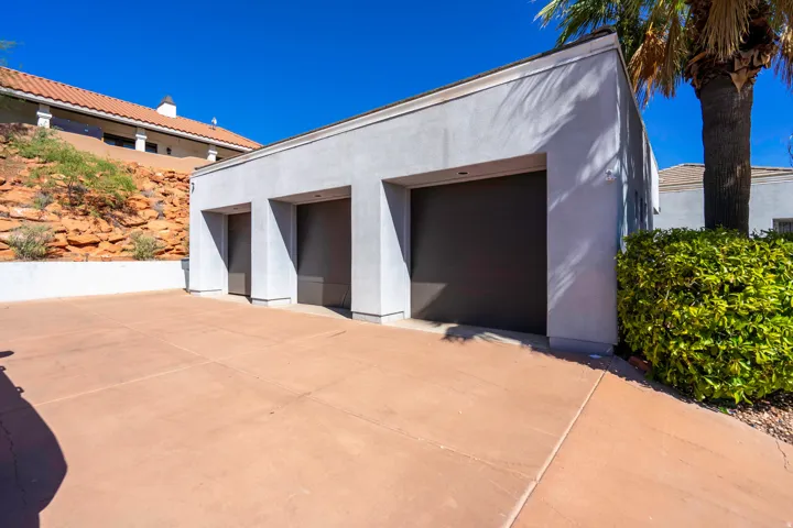 Three-car garage with gray stucco exterior