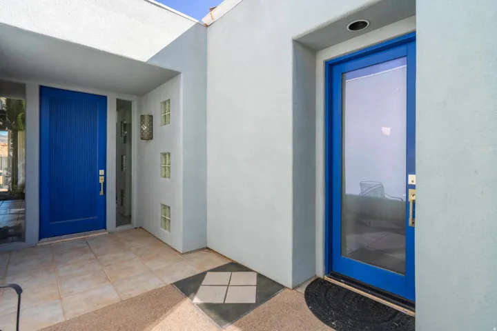 Dual blue entry doors with gold-finish hardware