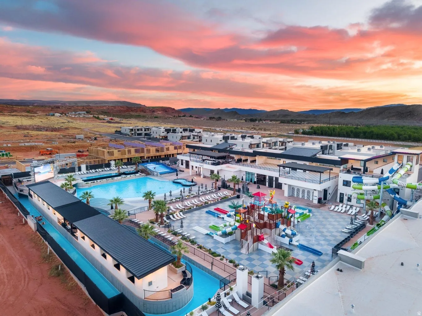 Community amenity center featuring multiple swimming pools, water slides, a lazy river, and a dedicated children's water play area