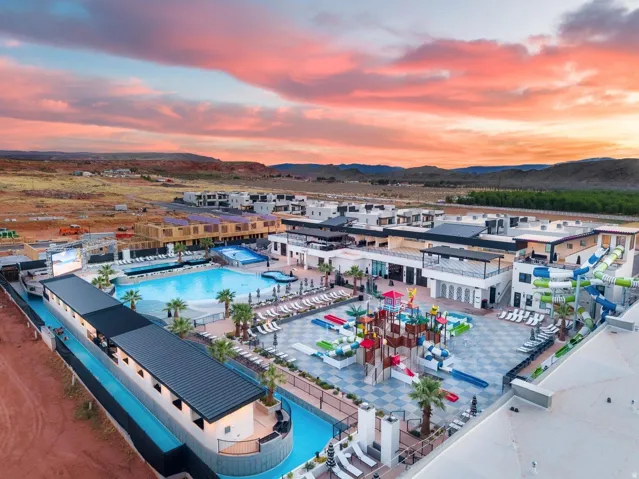 Community amenity center featuring multiple swimming pools, water slides, a lazy river, and a dedicated children's water play area