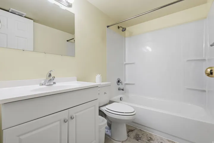 White vanity with integrated sink and chrome faucet