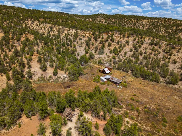 Aerial over the headquarters. Buildings sit in the sheltered draw with slope rising on both sides. All structures closed to entry