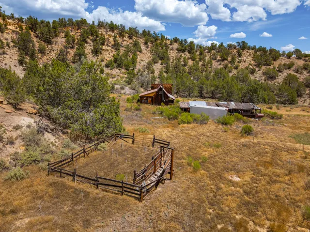 Corrals, loading chute, and outbuildings from above. Structures are closed to entry — exterior viewing only