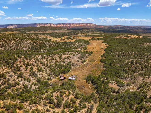 Headquarters complex in the drainage, East Zion on the horizon. Ranch road visible running north to the buildings