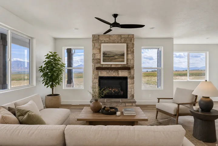 Virtually staged.  Stone-clad fireplace with a wood-finish mantel and hearth