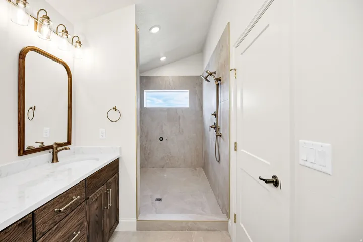 Custom vanity with a white countertop and bronze-finish hardware