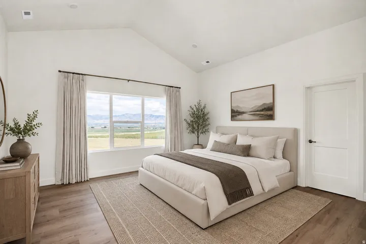 Virtually staged.  Vaulted ceiling, recessed lighting, expansive window with mountain scenery, wood-finish flooring, and a white paneled door