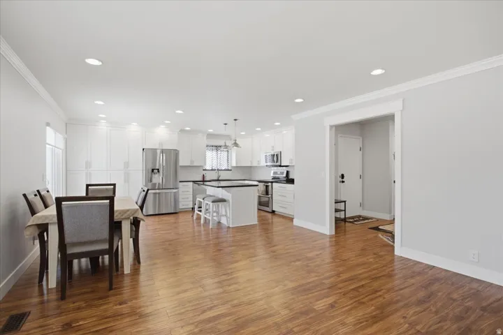 Wood-finish flooring throughout, recessed lighting, and crown molding