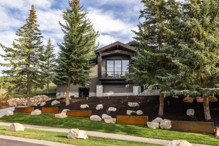 Dark-toned exterior with stone accents and a prominent balcony