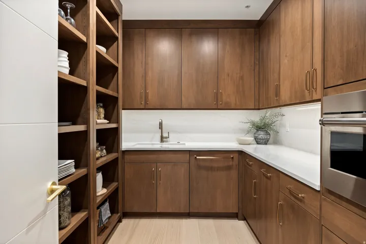 Extensive wood-finish cabinetry and open shelving with under-cabinet lighting