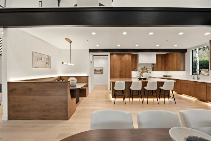 Gourmet kitchen with wood-finish cabinetry, a large center island, and integrated appliances