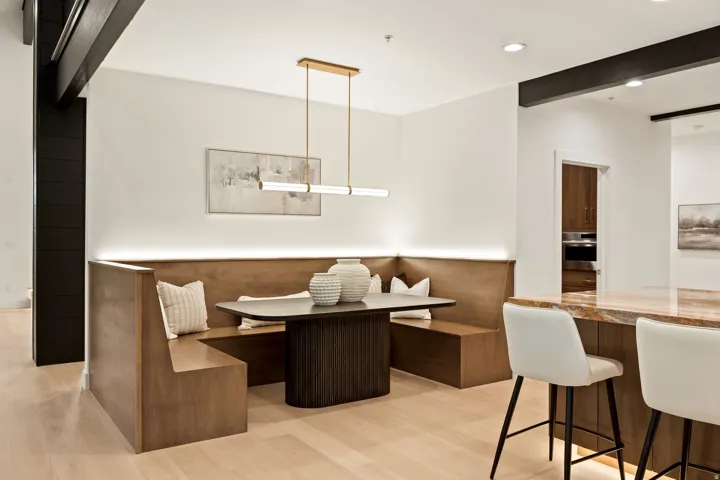 Integrated dining banquette with custom wood-finish seating and ambient lighting