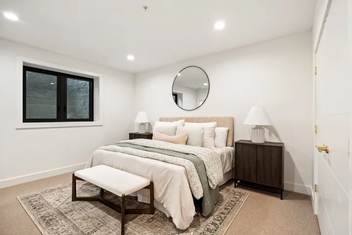 Recessed lighting, light neutral-toned carpeting, modern dark-framed window, contemporary paneled door, and built-in closet with gold-toned hardware