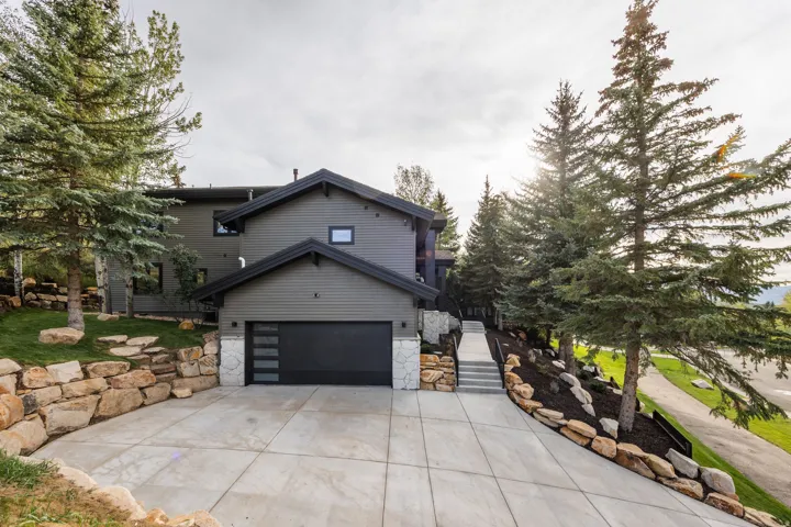 Contemporary exterior with dark siding and coordinating garage door