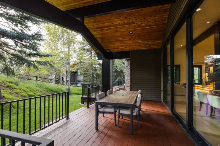 Expansive outdoor deck with wood-finish flooring and a wood-paneled ceiling