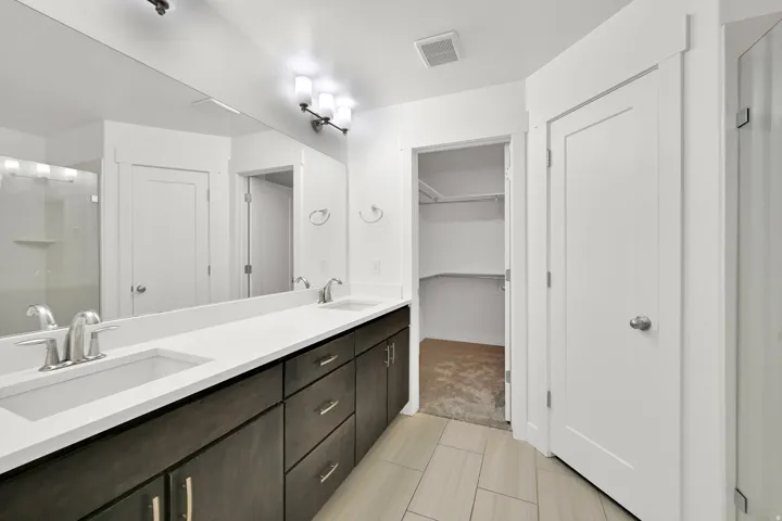 Dual vanity with undermount sinks, expansive mirror, and integrated lighting