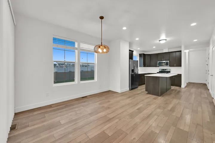 Open-concept main level with wood-finish flooring, recessed lighting, and a modern kitchen