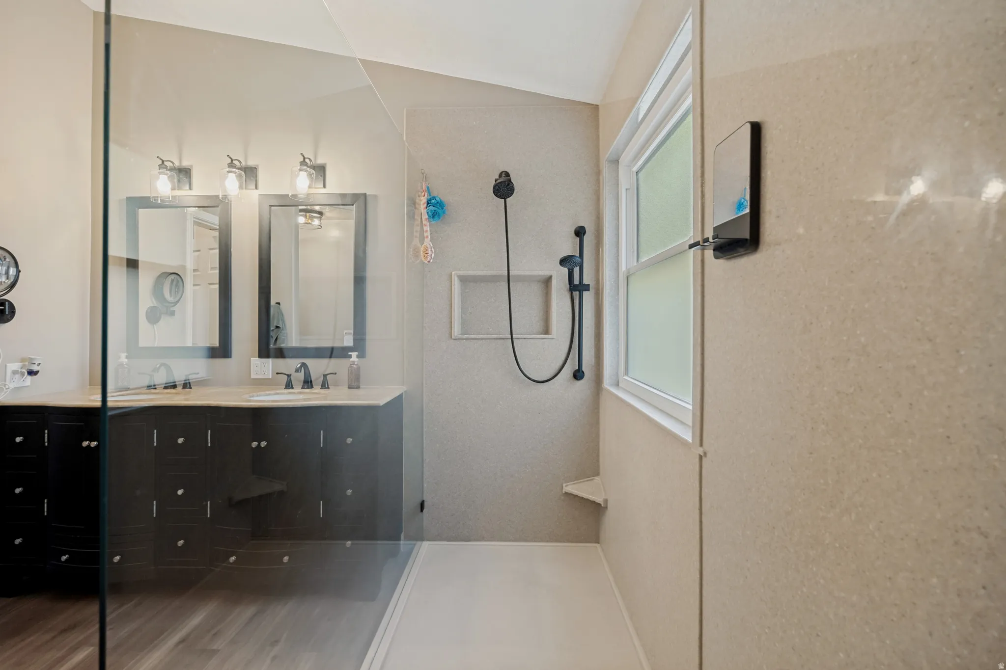 Glass-enclosed shower with a built-in niche and corner bench