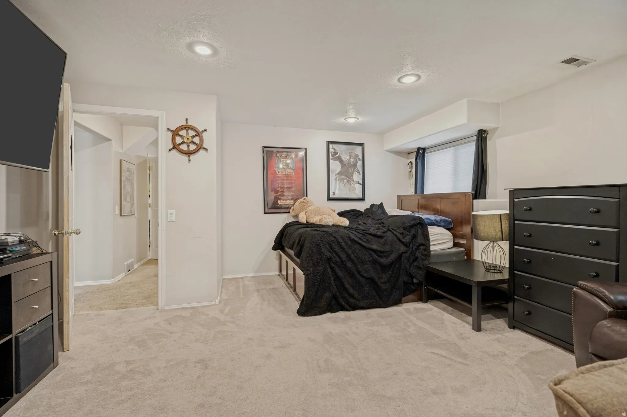 Recessed lighting, light gray carpeting, and white walls