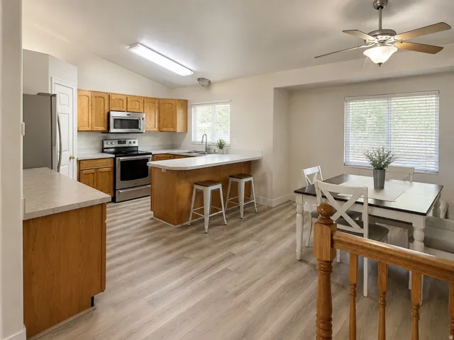 Kitchen with wood-finish cabinetry, stainless steel appliances, and light-toned countertops