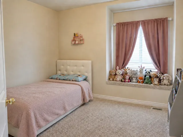 Plush carpeted flooring, window with blinds and drapes, and a built-in window seat