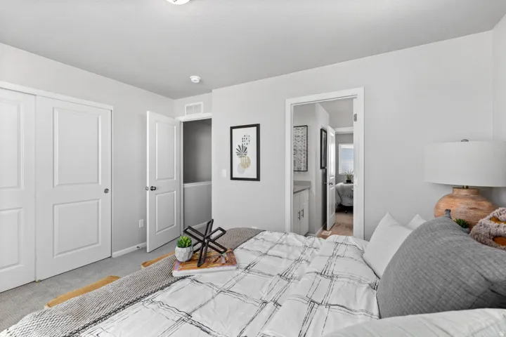 Bedroom featuring a ceiling light fixture, white interior doors, and light gray wall paint